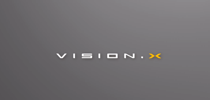 Mahindra Vision X electric SUV teaser logo on grey background