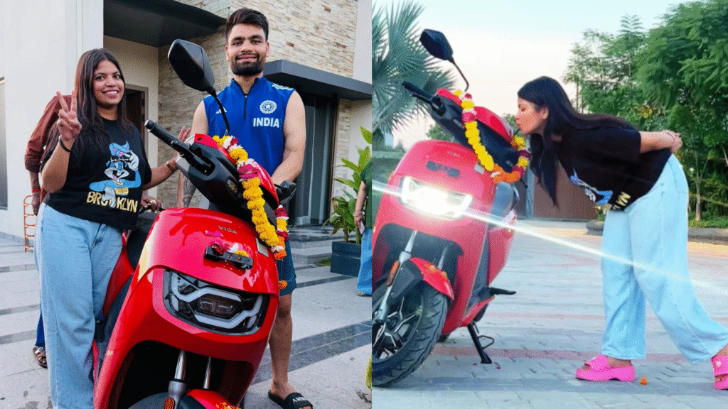 Rinku Singh अपनी बहन को लाल रंग का Vida VX2 Plus electric scooter गिफ्ट करते हुए।